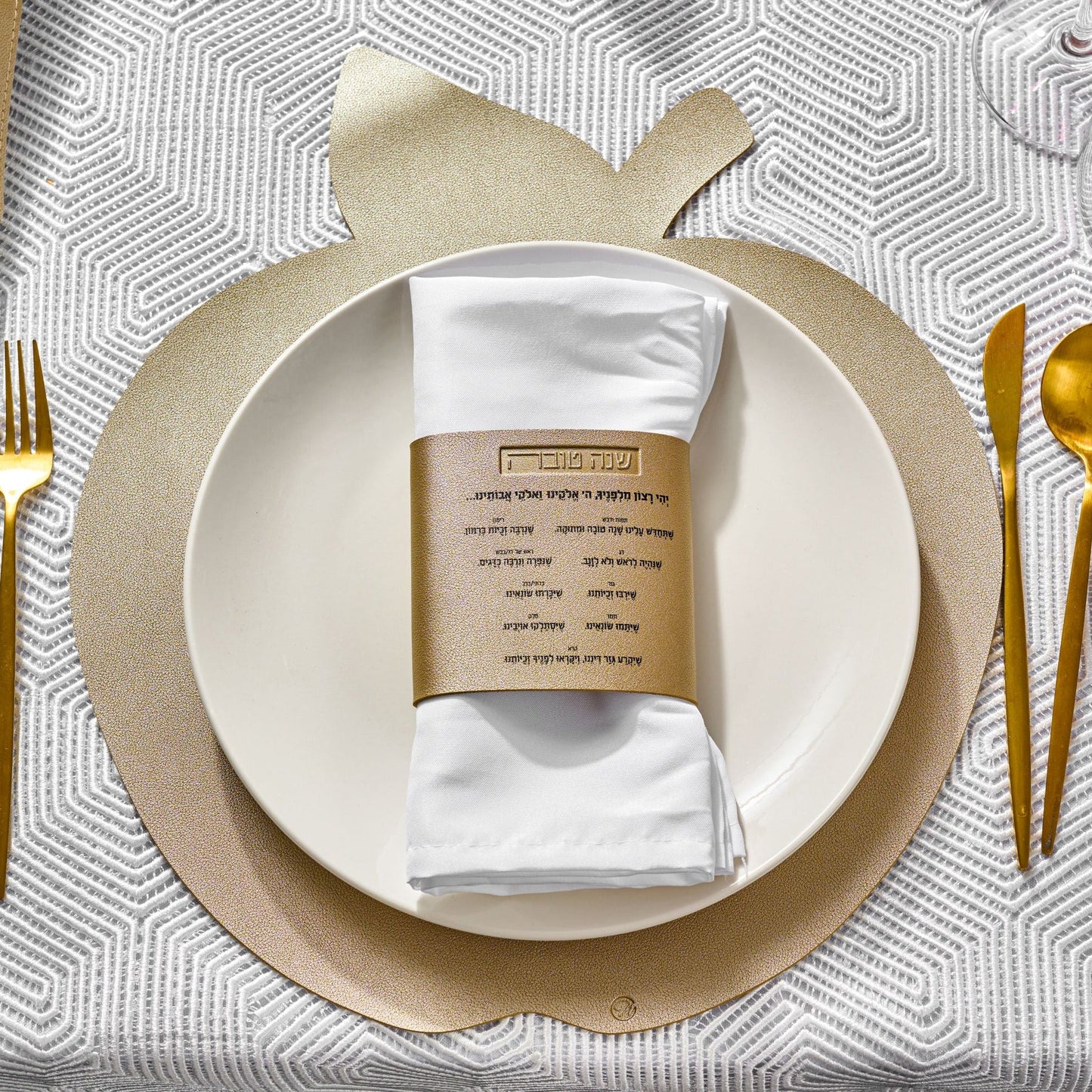Leather Simanim Napkin Wraps on a white plate and gold apple charger | Waterdale Collection