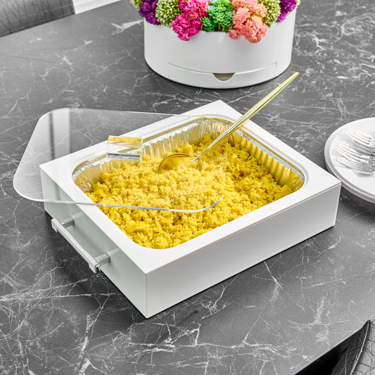 Classic 9x13 Pan Holder on a dark marble table beside a colorful floral centerpiece.