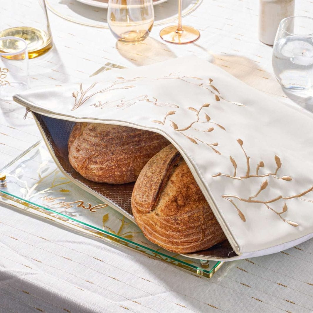 Embroidered Leaf Challah Pouch with bread inside and on on top of a challah board | Waterdale Collection