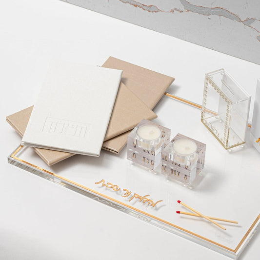 White and Gold Leather Tefillas Hashlah Book on top of a tray with tea light holder and matches | Waterdale Collection