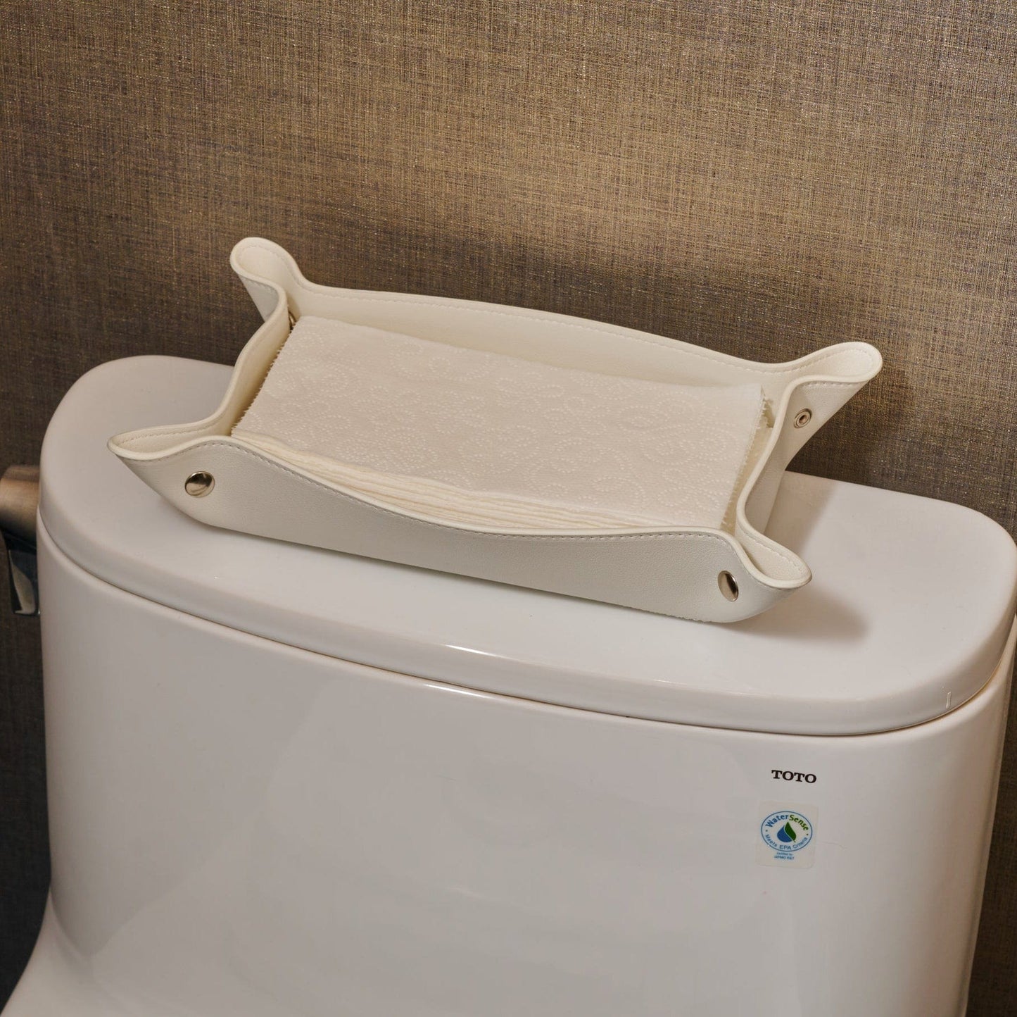 White Leather Shabbos Toilet Paper holder displayed on a toilet tank of a modern bathroom