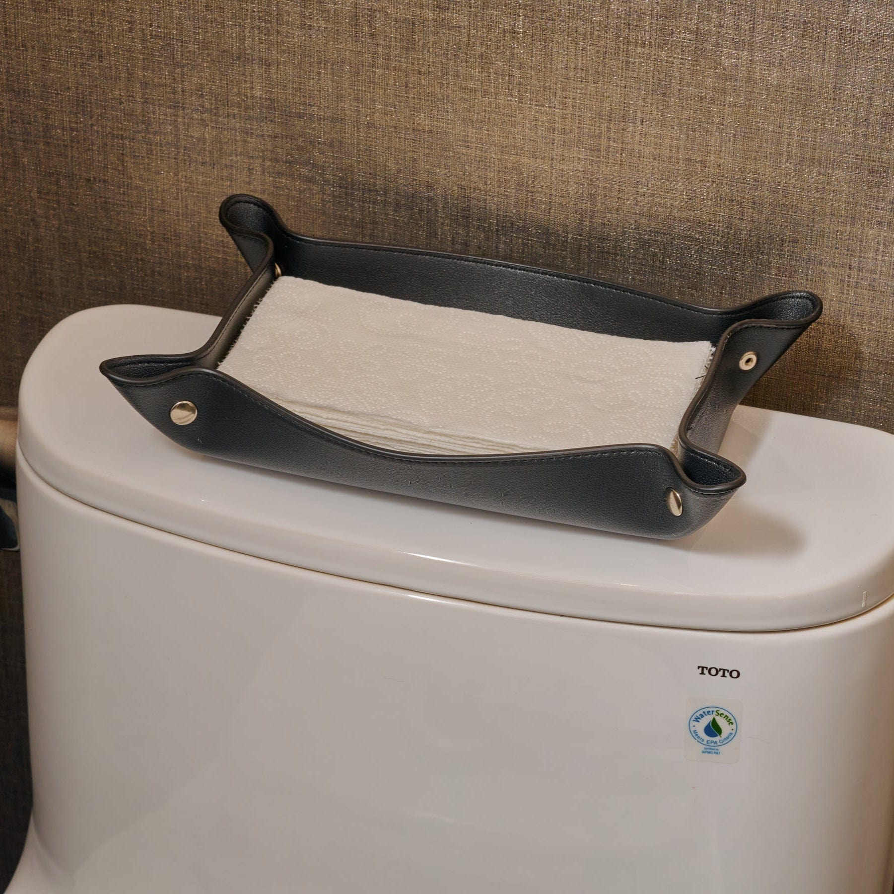 Black Leather Shabbos Toilet Paper holder displayed on a toilet tank in a modern bathroom