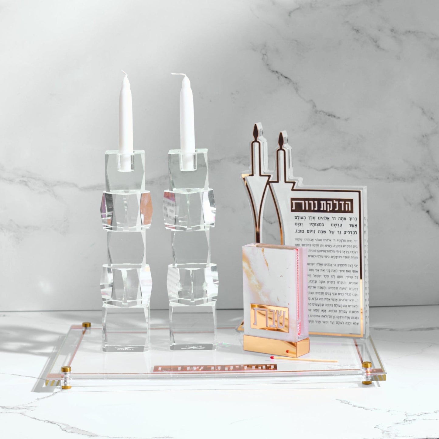 Classic 2.0 Hadlokas Neiros Sculpture, Marble Matchbox, and Candlesticks on top of a board