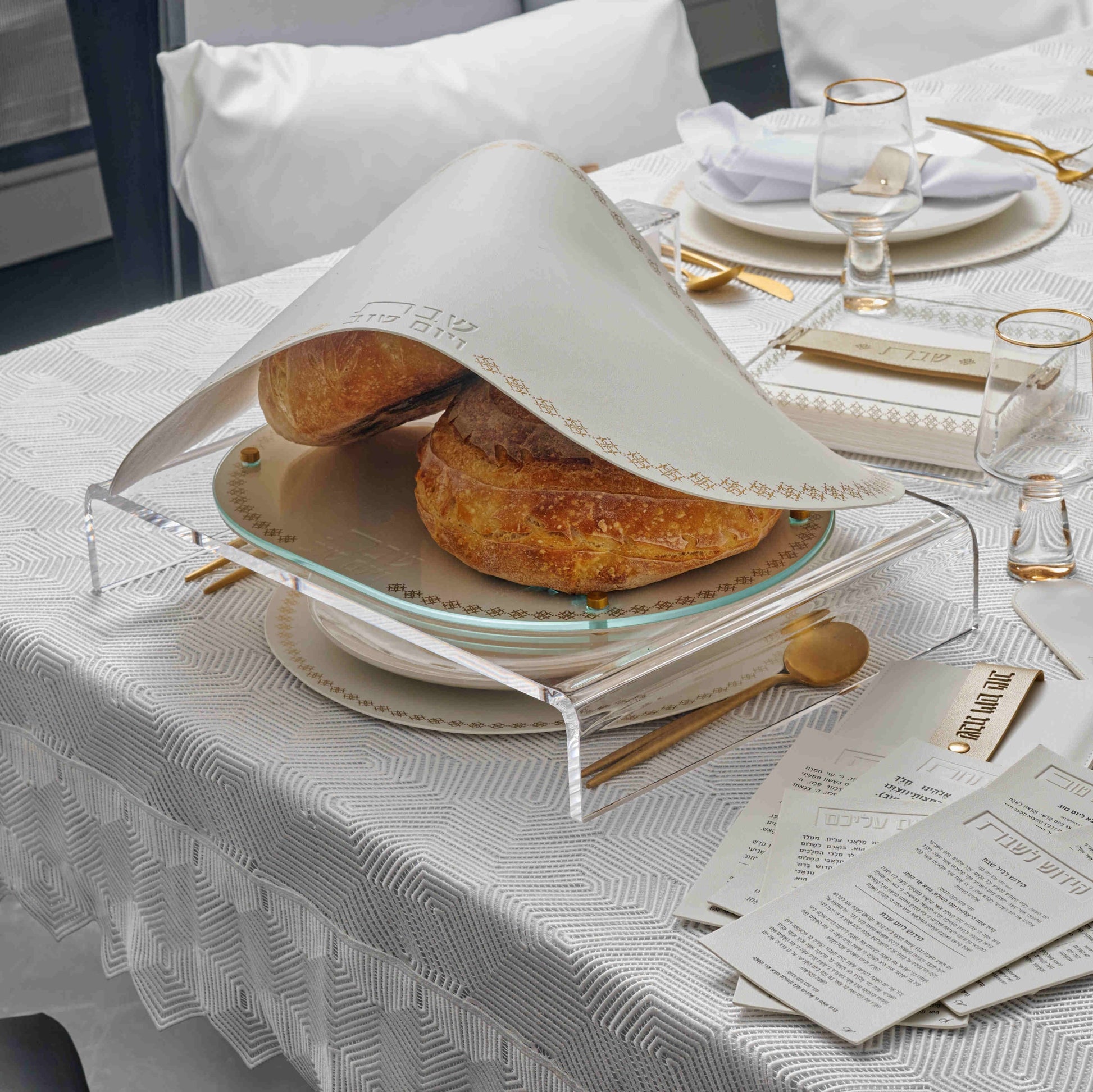 Suspended Marquesa Challah Board with round loaf bread on top and Suspended Marquesa Challah Covering it