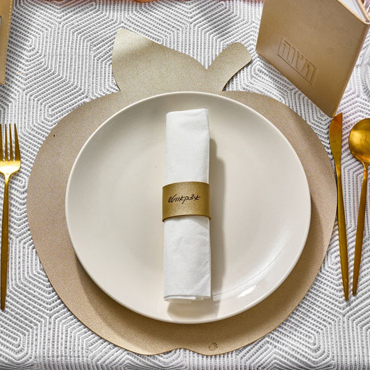 Personalized Leather Napkin Wraps on a festive gold and white table setting.