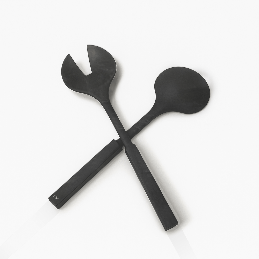 Two resin salad servers crossed on a white background